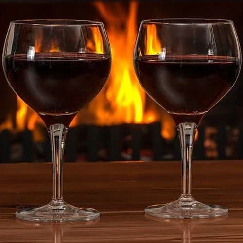 Wine glasses by a fireplace